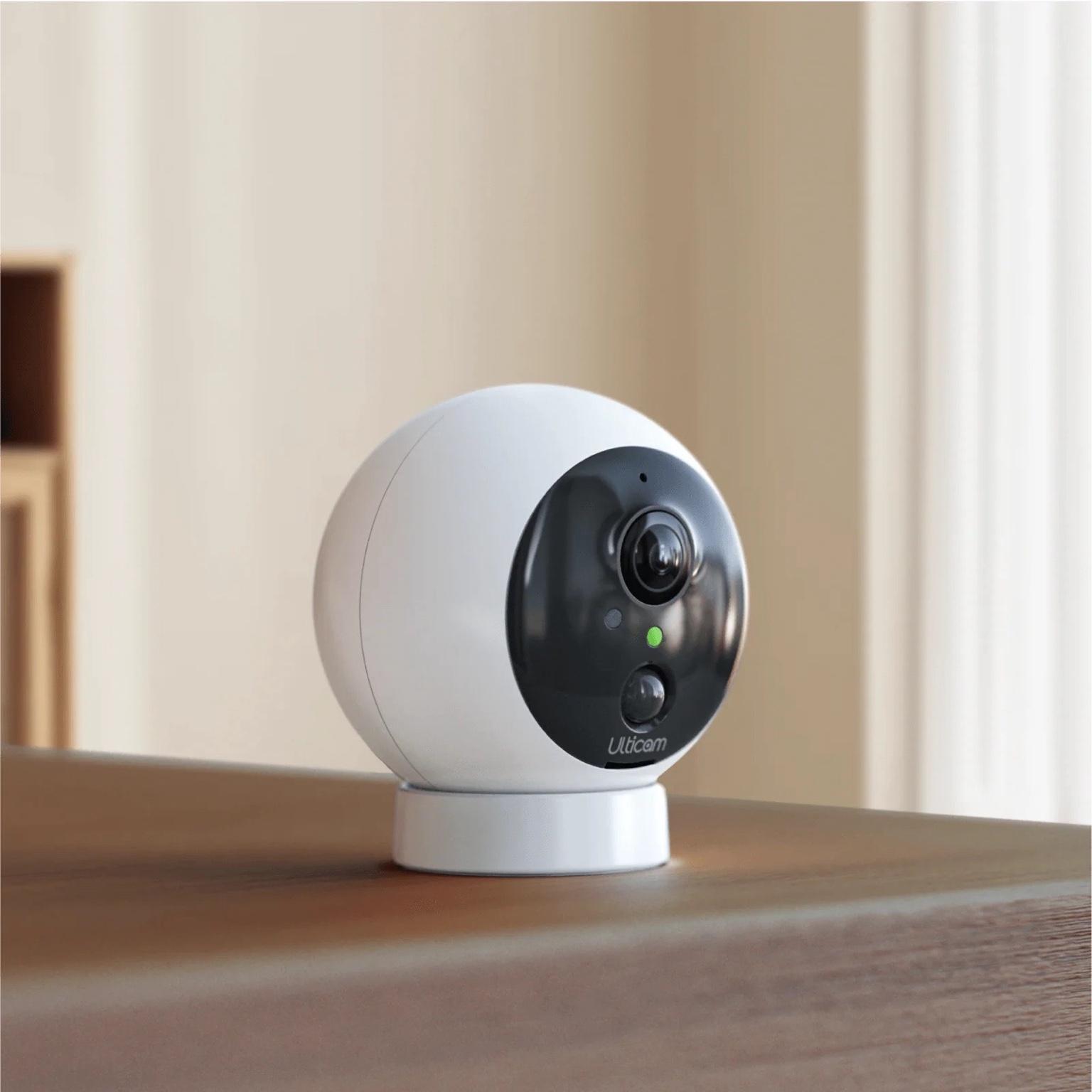 Ulticam Dot 2K UHD Wireless Security Camera Kit – Smart WiFi home security camera with AI motion detection and night vision, lifestyle setup on table.